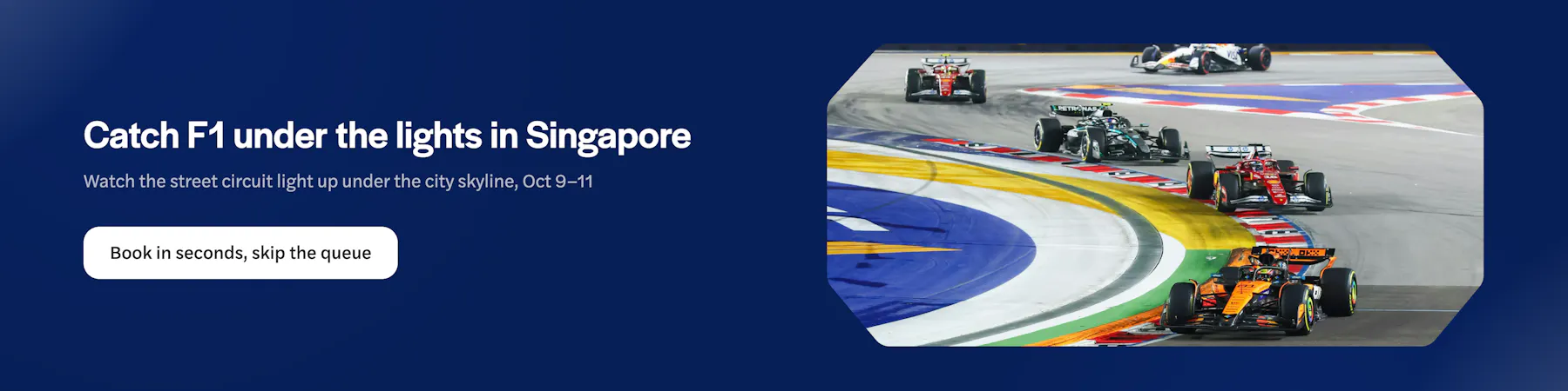 Formula 1 cars racing at Singapore Grand Prix night circuit.